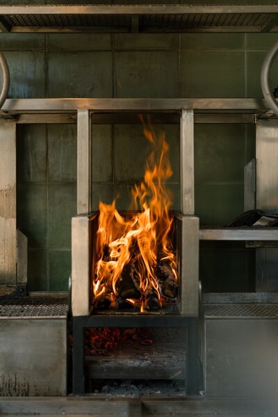 Cooking over a wood fire at a beachfront restaurant near Kuta Lombok