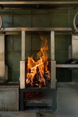 Cooking over a wood fire at a beachfront restaurant near Kuta Lombok