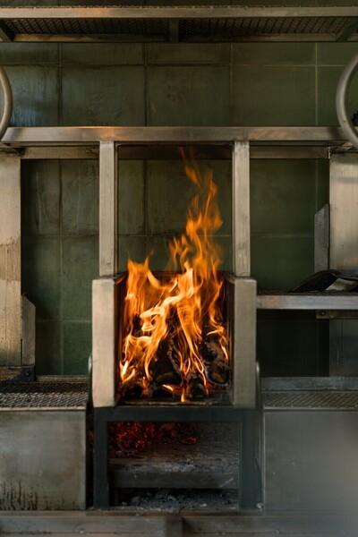 Cooking over a wood fire at a beachfront restaurant near Kuta Lombok