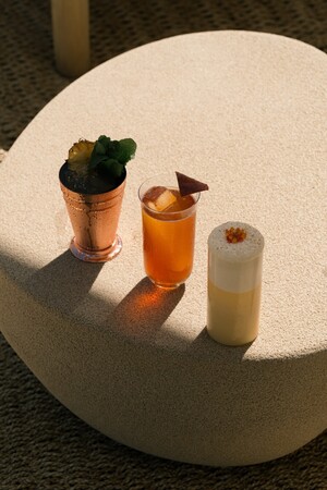 House cocktails on the beachfront terrace at Codium during golden hour